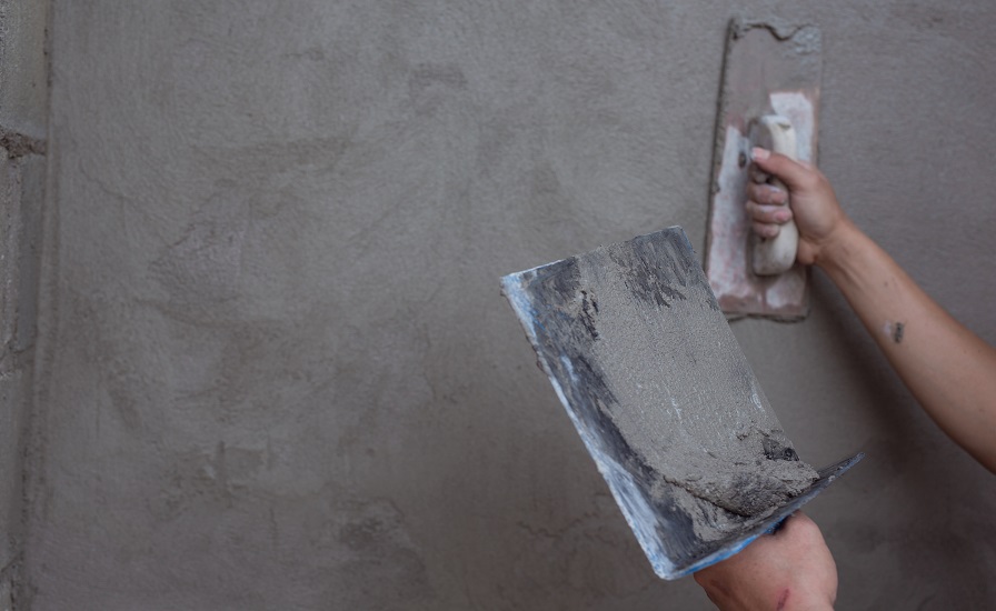 Plasterer renovating indoor walls.